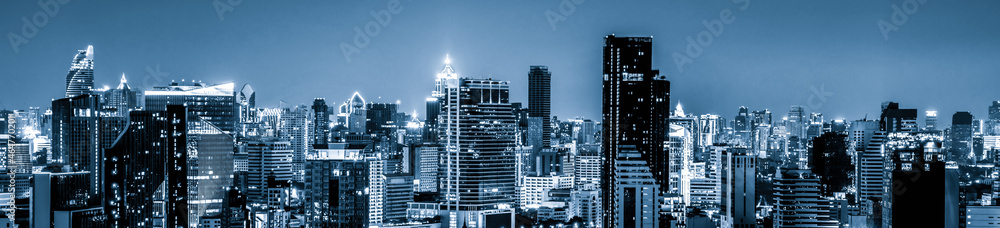 Blue-filtered cityscape and high-rise buildings in metropolis city center . Downtown business district in panoramic view . - obrazy, fototapety, plakaty 