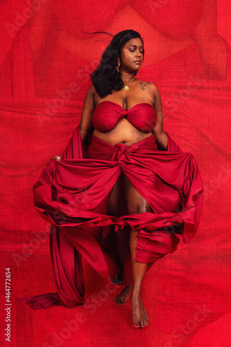 Photography Malaysian Indian individual dressed in red clothing, against a red background, p