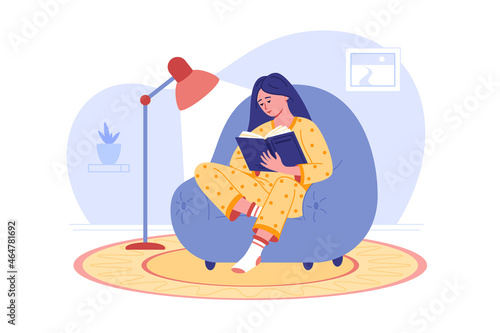 Girl reading book in cozy chair