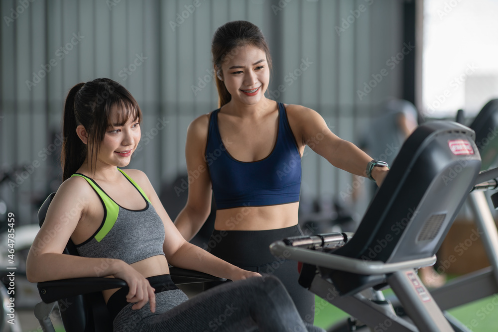 Female fitness trainer is discussing program with woman on a treadmill Female fitness trainer is discussing program with woman on a treadmill