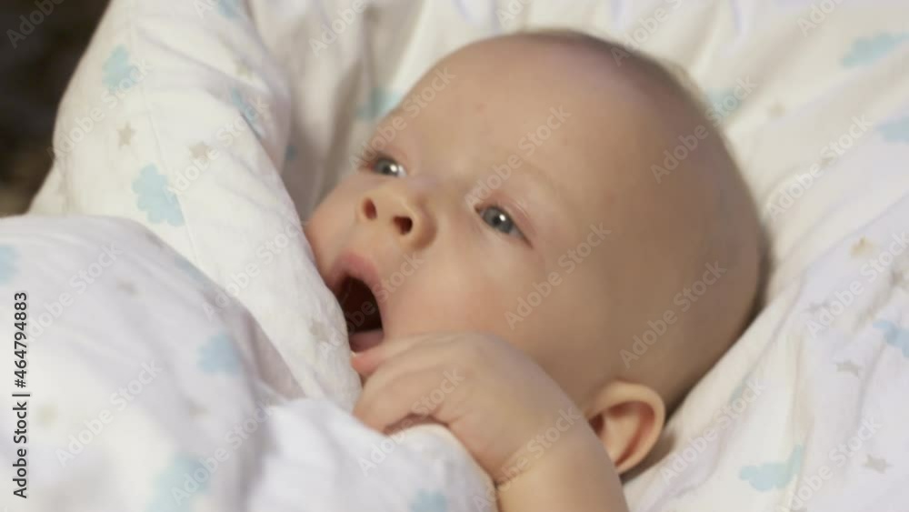Baby falling asleep in baby rocker afternoon nap, caucasian six month old infant face closeup. High quality 4k footage Baby falling asleep in baby rocker afternoon nap, caucasian six month old infant face closeup. High quality 4k footage