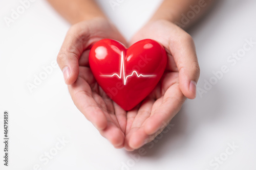 The man is holding a red heart. Charity  health insurance  love  and international cardiology day concepts.