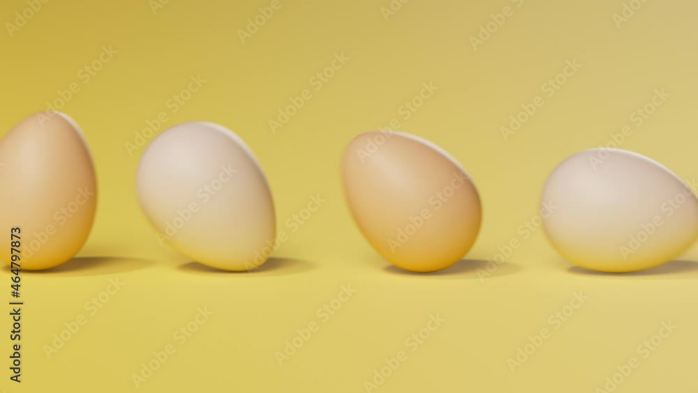 Rolling eggs on a yellow pastel background. Happy Easter. Spring celebration. Rolling eggs on a yellow pastel background. Happy Easter. Spring celebration.