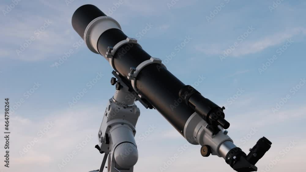 Silhouette of big astronomical telescope under the twilight sky.	
