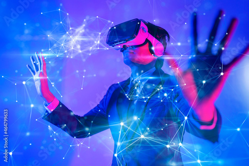 Metaverse digital cyber world technology, man with virtual reality VR goggle playing AR augmented reality game and entertainment, futuristic metaverse gameFi NFT game ideas photo