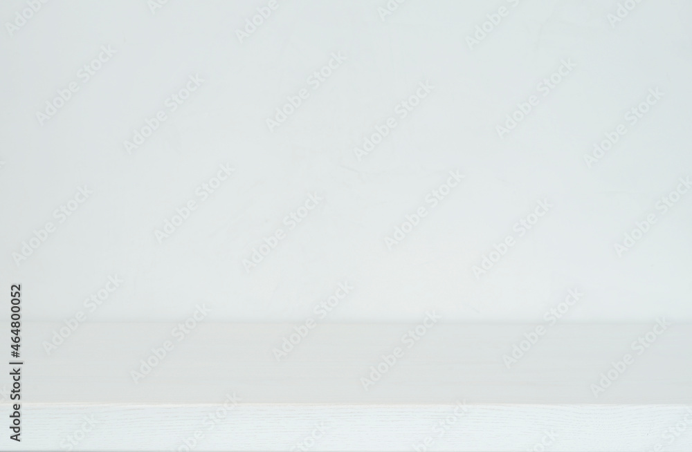 Background image for mockup, background for still life in light gray and white tones, wooden table surface and wall with Venetian plaster Background image for mockup, background for still life in light gray and white tones, wooden table surface and wall with Venetian plaster