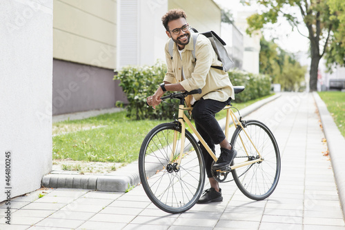 Handsome happy young man with bicycle on a city street. Active lifestyle, people, city life, having fun, enjoying life concept