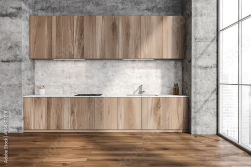 Concrete wall with minimalist wood kitchen cabinet
