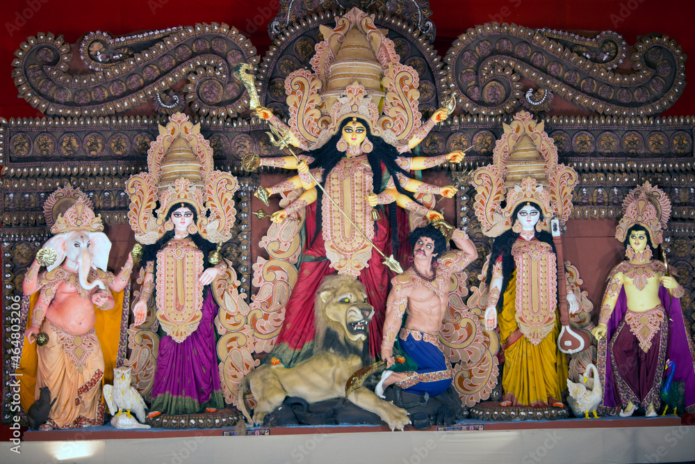Goddess Durga idol at decorated Durga Puja pandal, shot at colored light, in Kolkata, West Bengal, India. Durga Puja is biggest religious festival of Hinduism and is now celebrated worldwide.
