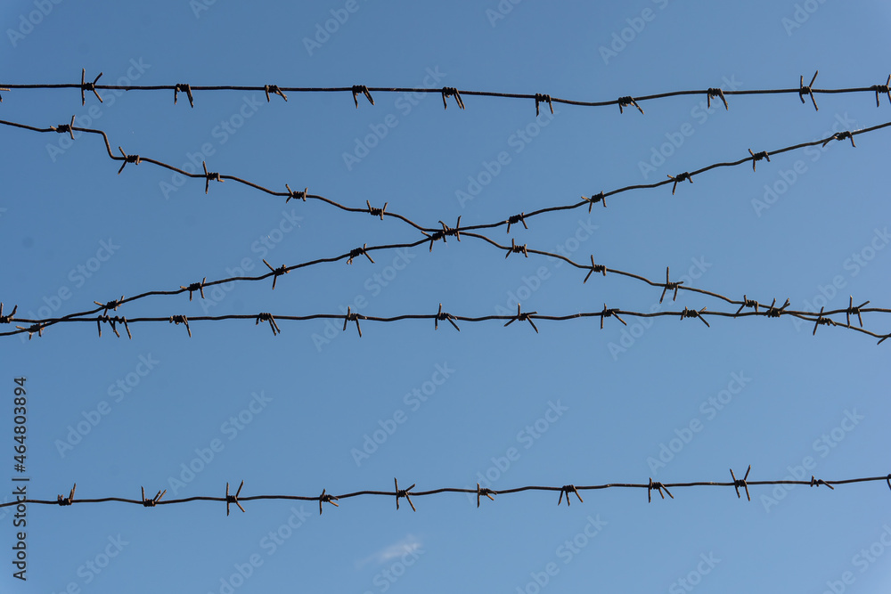 Rusty barbed wire clear blue sky background Rusty barbed wire clear blue sky background