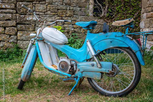 Old blue rusty motorcycle in The little artists Village Groznjan, Istria, Croatia. Tomos (Tovarna) was a moped manufacturer based in Koper, Slovenia photo