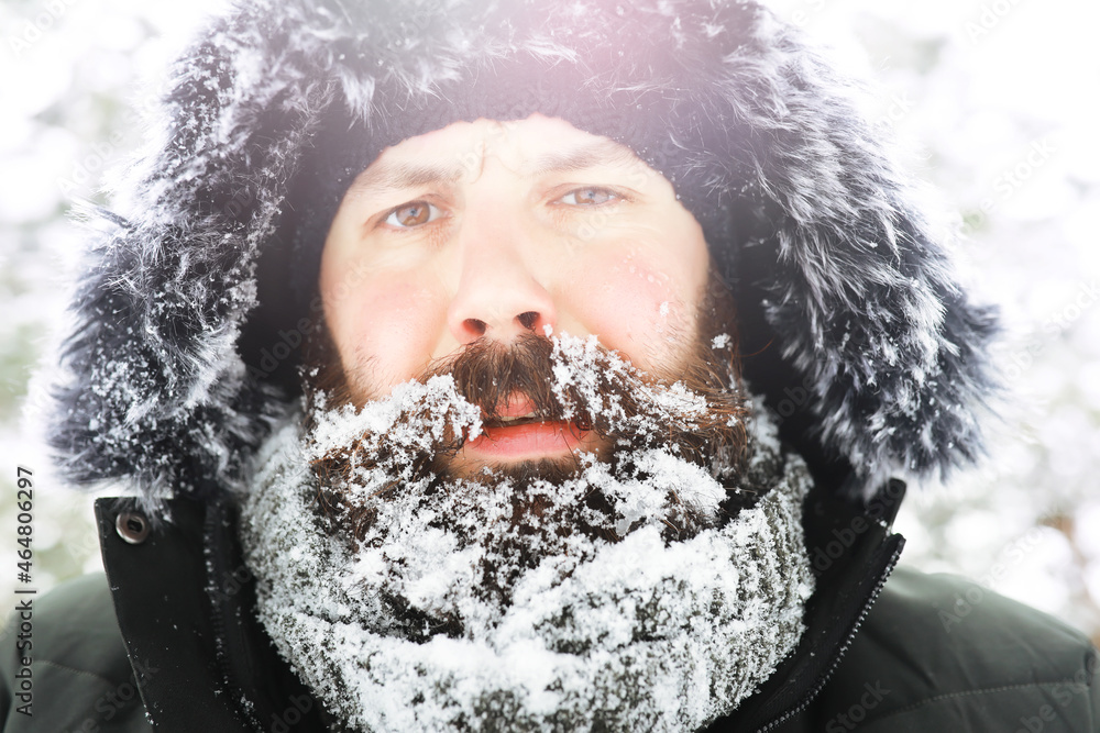 Outdoor portrait of handsome man in coat and scurf. Bearded man in the winter woods. Outdoor portrait of handsome man in coat and scurf. Bearded man in the winter woods.