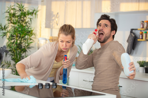 unhappy couple doing the cleaning