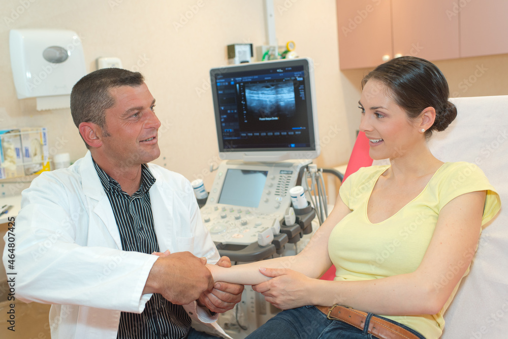 a doctor examining patients arm a doctor examining patients arm