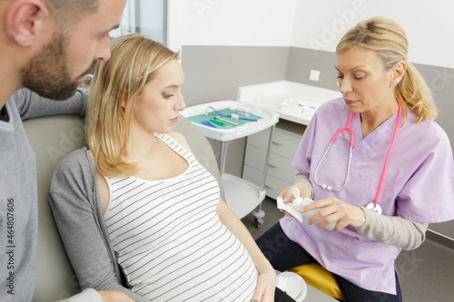 young pregnant woman with doctor at the hospital