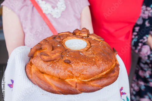 a woman holds a wedding loaf in her hands