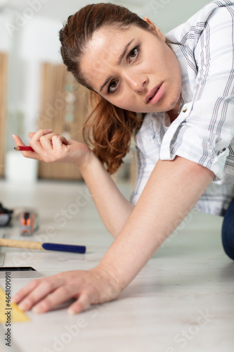 confused young woman working with wood