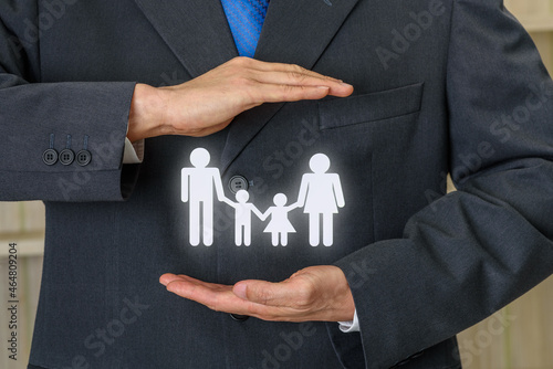 Family life insurance, financial security concept : Businessman protects family members e.g parents and two child, depicts protection from insurer, they will pay a lump sum for clearing burden of debt