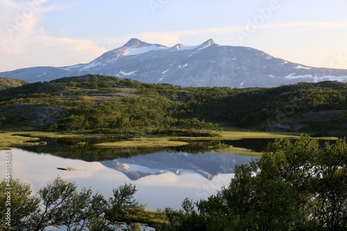 A mountain in the distance reflecting in a small lake in northern Norway 