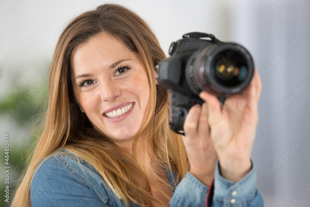 beautiful and attractive woman holding a professional dslr camera
