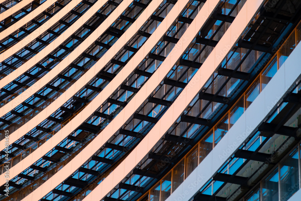 Architectural and construction background. Fragment of an unfinished multi-story residential building or commercial property against background of sky at sunset Architectural and construction background. Fragment of an unfinished multi-story residential building or commercial property against background of sky at sunset