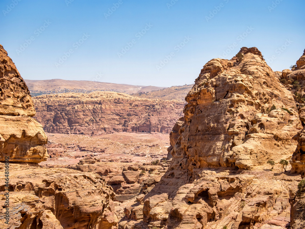 Mountain wall of red sand rock that surround the ancient city of Petra, Jordan. Rocky desesrt landscape