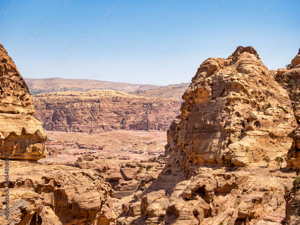 Mountain wall of red sand rock that surround the ancient city of Petra, Jordan. Rocky desesrt landscape Mountain wall of red sand rock that surround the ancient city of Petra, Jordan. Rocky desesrt landscape