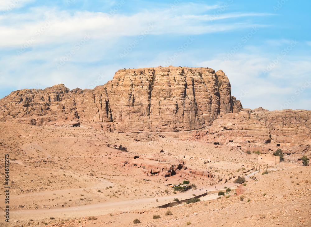 Fototapeta premium Aerial scene from the ancient city of Petra, Jordan. View of the Colonnaded Street and a massive rock red mountain in the background