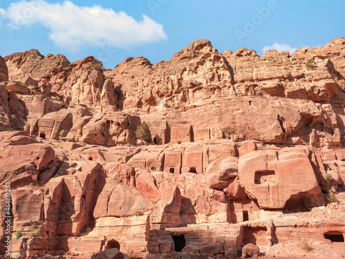 Ancient housing carved in red sand rock in the city of Petra, Jordan. Detail with Tomb of 'Unayshu