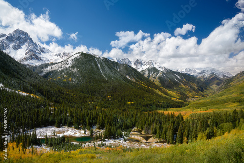 Beautiful landscape photo of aspen and pine trees in valley, Snow covered on mountain range Colorado