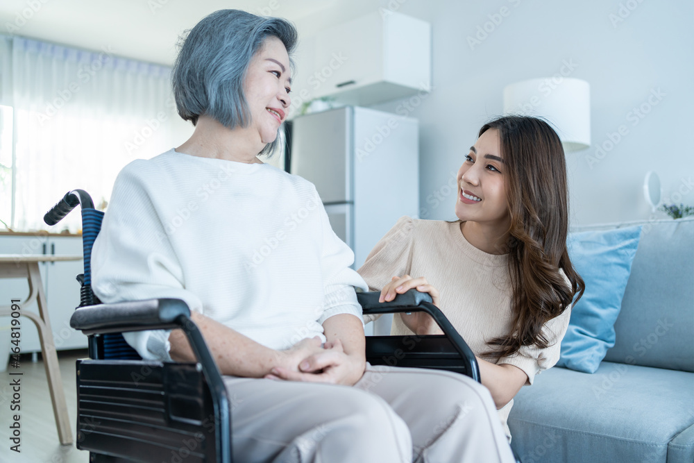Asian young daughter support old disabled woman on wheelchair at home. Asian young daughter support old disabled woman on wheelchair at home.