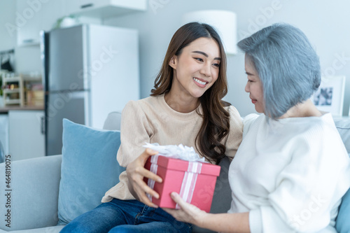 Asian beautiful woman daughter surprise her mother with birthday gift.