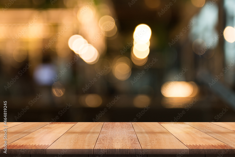 Empty wooden table top with lights bokeh on blur restaurant background. Empty wooden table top with lights bokeh on blur restaurant background.