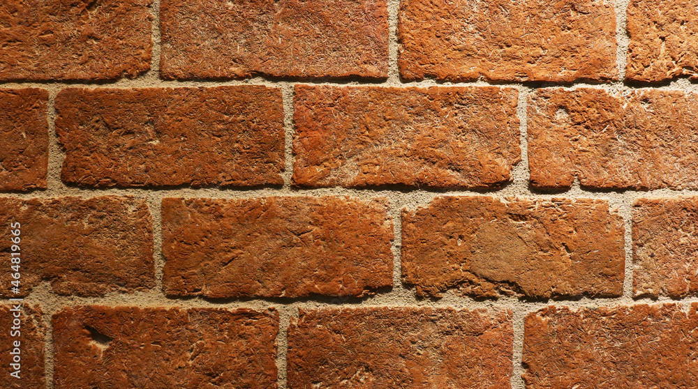 Fototapeta premium Close-up red brick pattern texture background in dark light.