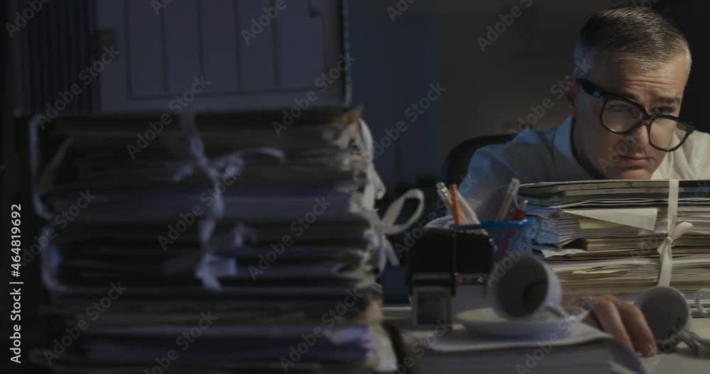 Exhausted businessman working overtime at night Exhausted businessman working overtime at night