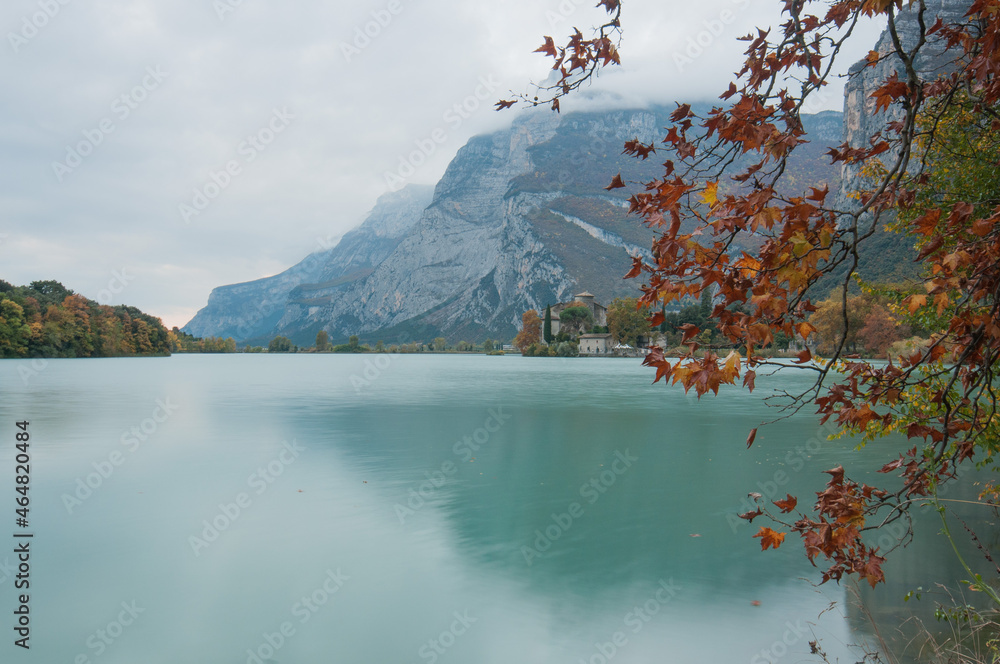Fototapeta premium landscape with lake autumn.Autumnal plane tree branch that frames the background castle tablino