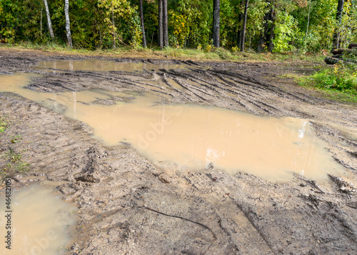 Fotografie landscape with muddy and sticky forest road, dirty field road, autumn