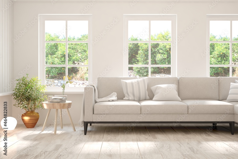 Fototapeta premium White living room with sofa and summer landscape in window. Scandinavian interior design. 3D illustration