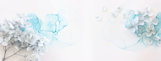 Creative image of pastel blue Hydrangea flowers on artistic ink background. Top view with copy space