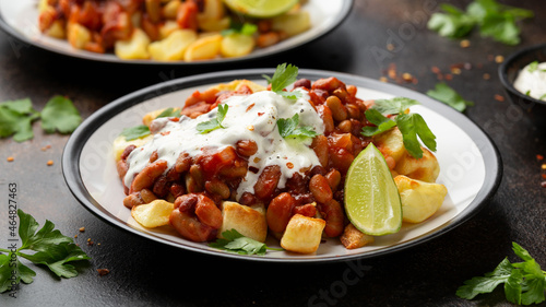 Spicy Bean Chilli with Baked Potato, sour cream and lime. Healthy Food
