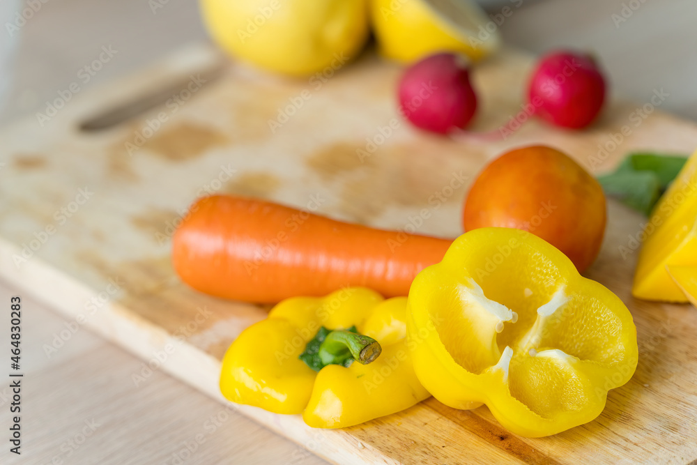 Healthy living and Vegan food. Cooking vegan food. Ingredients fruits and vegetables on the chopping board. Bell peppers, carrots, tomatoes. Healthy living and Vegan food. Cooking vegan food. Ingredients fruits and vegetables on the chopping board. Bell peppers, carrots, tomatoes.