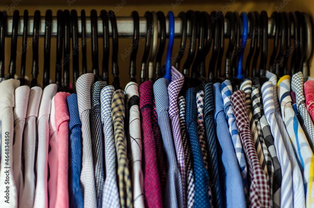 Men's shirts on hangers in the wardrobe