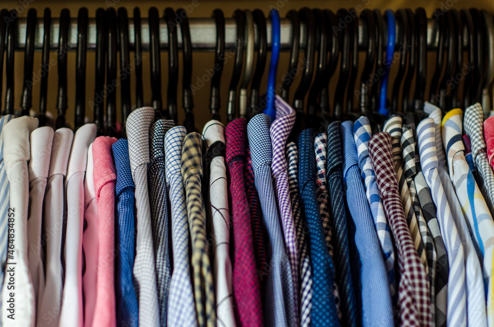 Men's shirts on hangers in the wardrobe