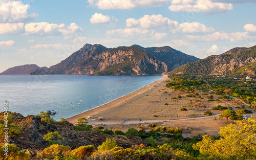 Fototapeta Naklejka Na Ścianę i Meble -  Picturesque beach in Cirali village. Sea mountains and pine trees on the beach. Kemer, Antalya, Turkey.