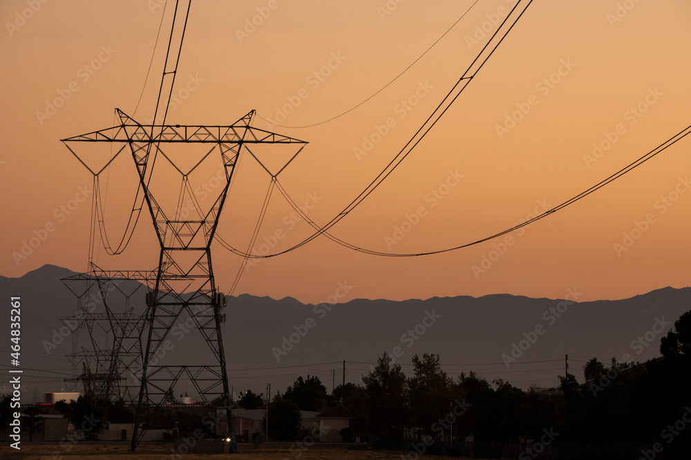 Power transmission tower on an orange sky.