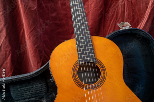 Acoustic Guitar on red background. Classic guitar concept.