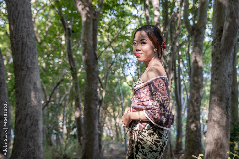 Balinese girl posing in nature and in a forest on Candidasa's offshore islands in Bali, dressed in a traditional costume. Balinese girl posing in nature and in a forest on Candidasa's offshore islands in Bali, dressed in a traditional costume.