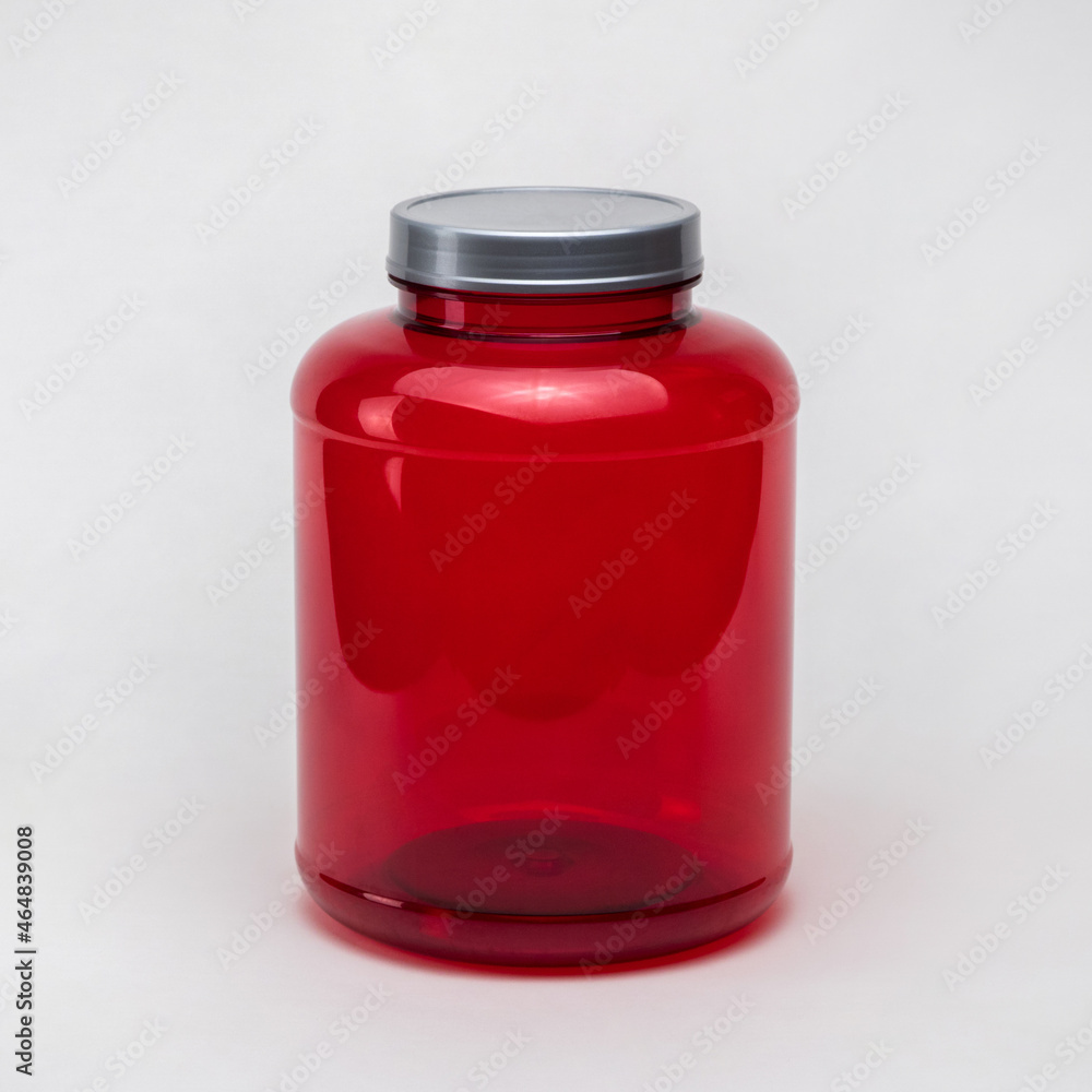 Large red transparent plastic pill jar on white background. Isolated Large red transparent plastic pill jar on white background. Isolated