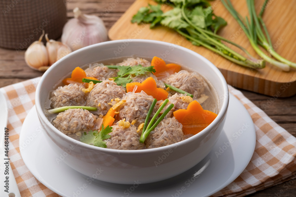 Close up Clear glass noodle soup with Minced Pork and carrot.Asian Meatball Soup with cellophane noodle (Gaeng Jued Woon Sen) Close up Clear glass noodle soup with Minced Pork and carrot.Asian Meatball Soup with cellophane noodle (Gaeng Jued Woon Sen)
