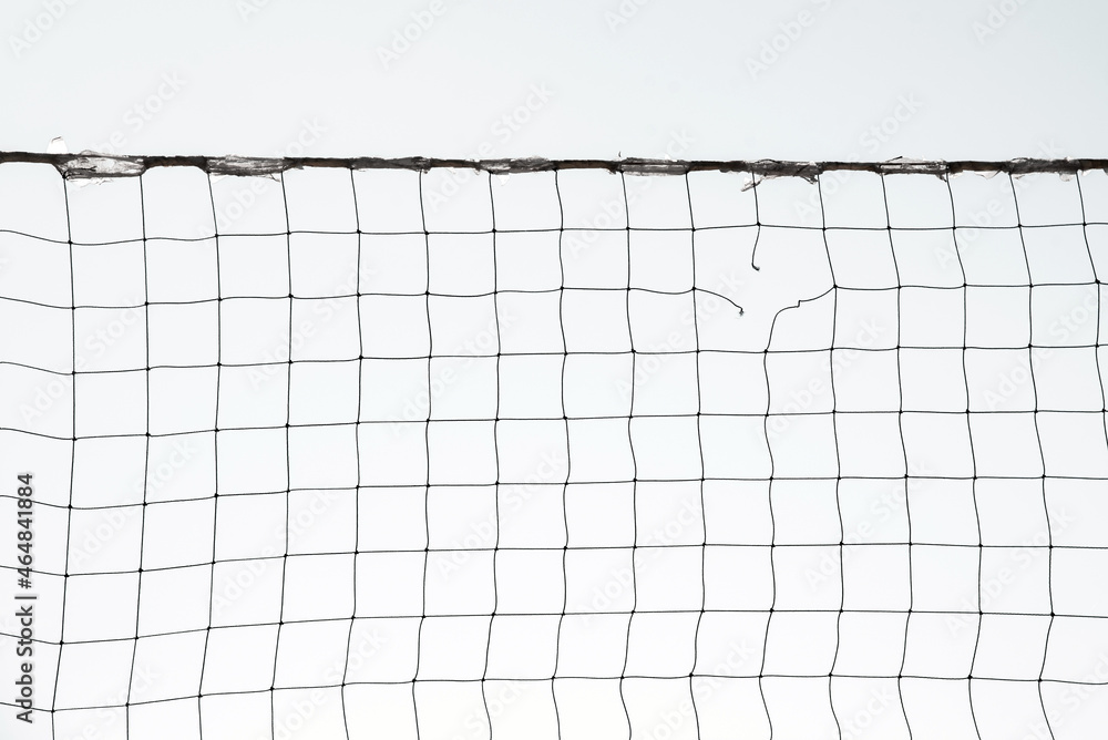 Torn volleyball net on sky background (failure, loss, breakdown - concept)